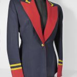 Navy blue jacket with red lapels and red cuffs. Gold bands around collar and two gold band above red sleeve cuffs.