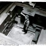 Man stands inside a mould for heavy duty engine lathe, showing mould for head casting before settling cores.