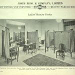 Illustration of an up to date beauty parlour in 1930. There are room dividers, rugs, manicure tables, a hair dressing chair and a large mirror on the wall.