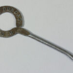 metal button hook, with H.C. Clarke Dundas stamped on the circular handle