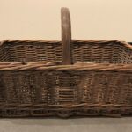 Rectangular wicker basket with handle, viewed from the side