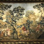 Tapestry depicting farm workers at different stages of harvest with trees and houses in the background