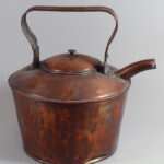 Large copper kettle with spout and an upright handle