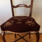 Dark wood dining chair with burgundy embroidered seat