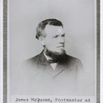 Portrait of James McQueen. He has short hair and beard, wearing suit and bow-tie.