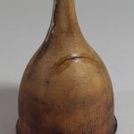Wood funnel standing upright. There is a crack in the bowl of the funnel.