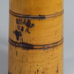 Yellow cylinder container with writing: "QUART C.S.B."